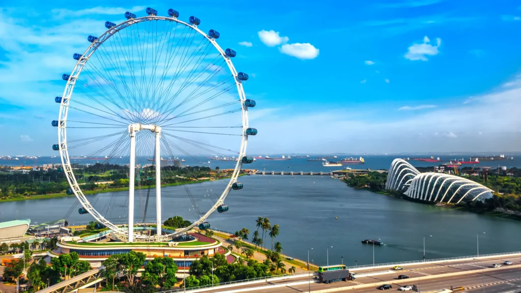 A stunning aerial view of Singapore's skyline from the Singapore Flyer observation wheel | showcasing Marina Bay Sands and Gardens by the Bay | Triumph Holidays